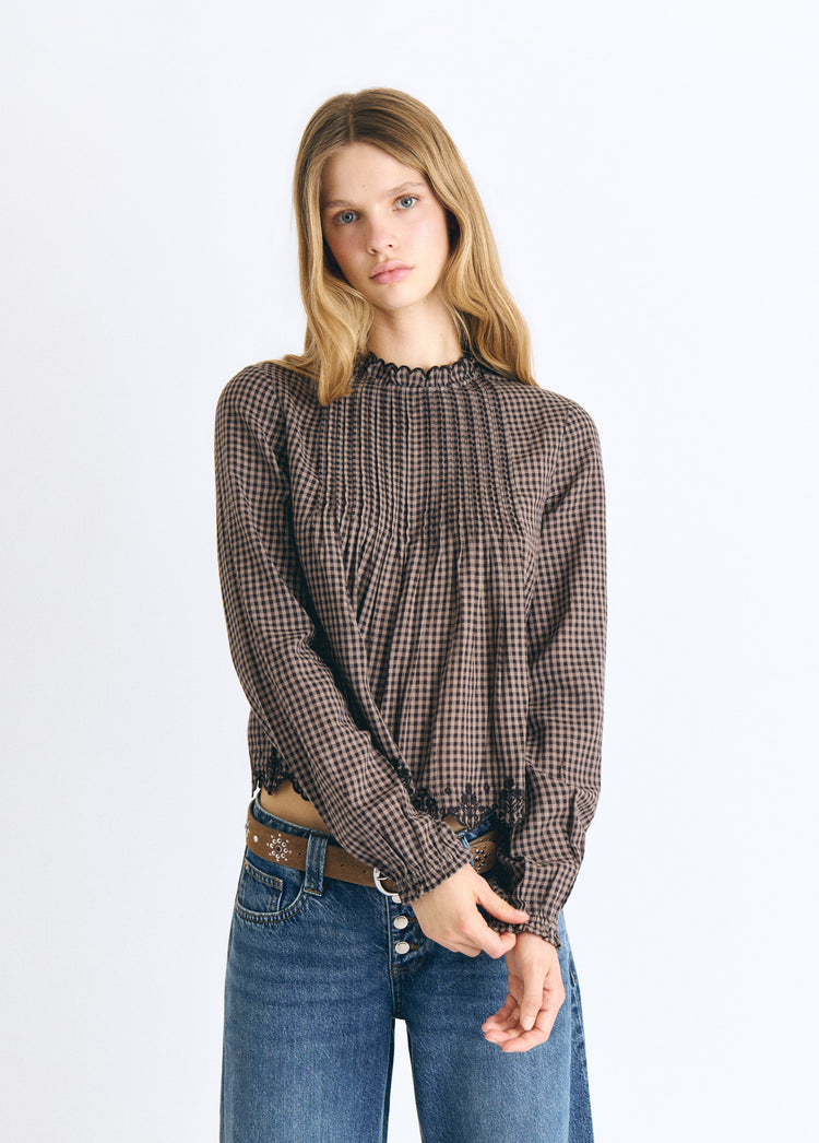 Blusa a quadri con orlo ricamato