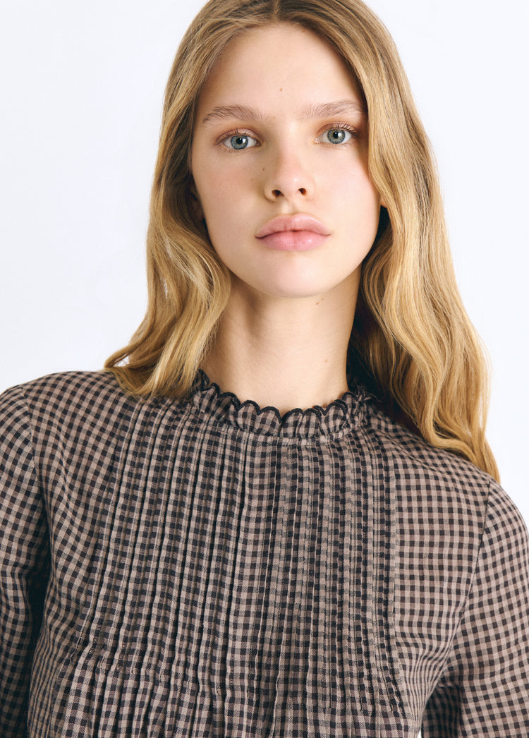 Blusa a quadri con orlo ricamato
