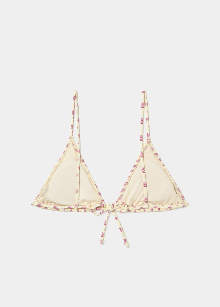 Top de bikini triangular con frunces, lazo frontal y estampado floral sobre fondo amarillo