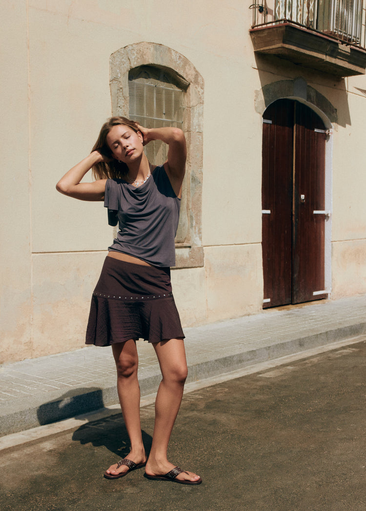 Short skirt with asymmetrical hem and studs