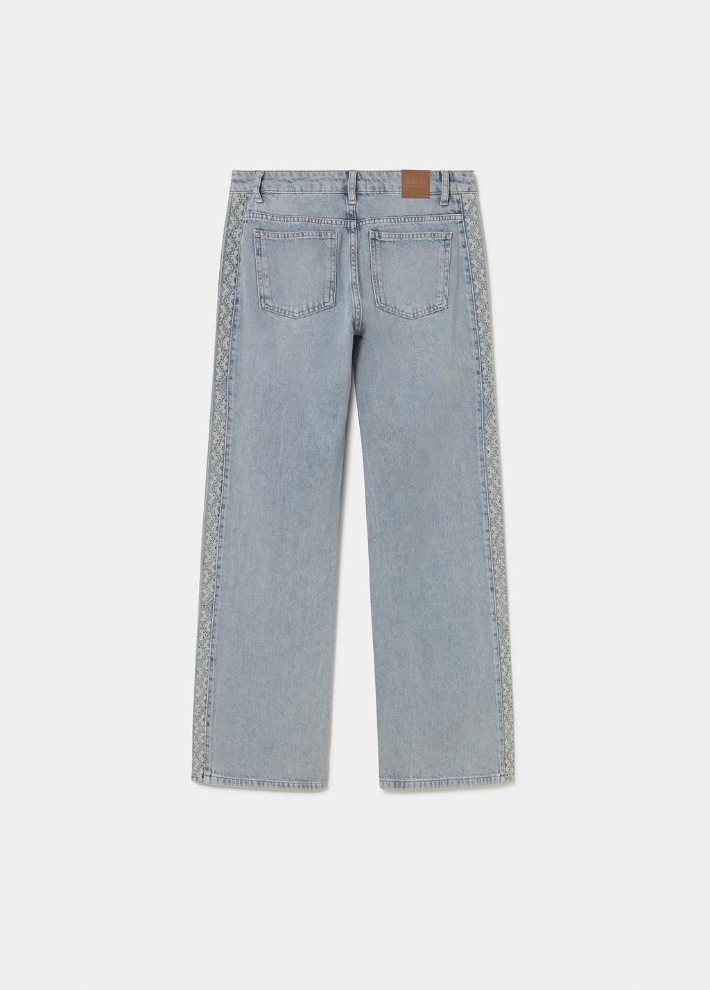 Jeans pieza lateral punto cruz