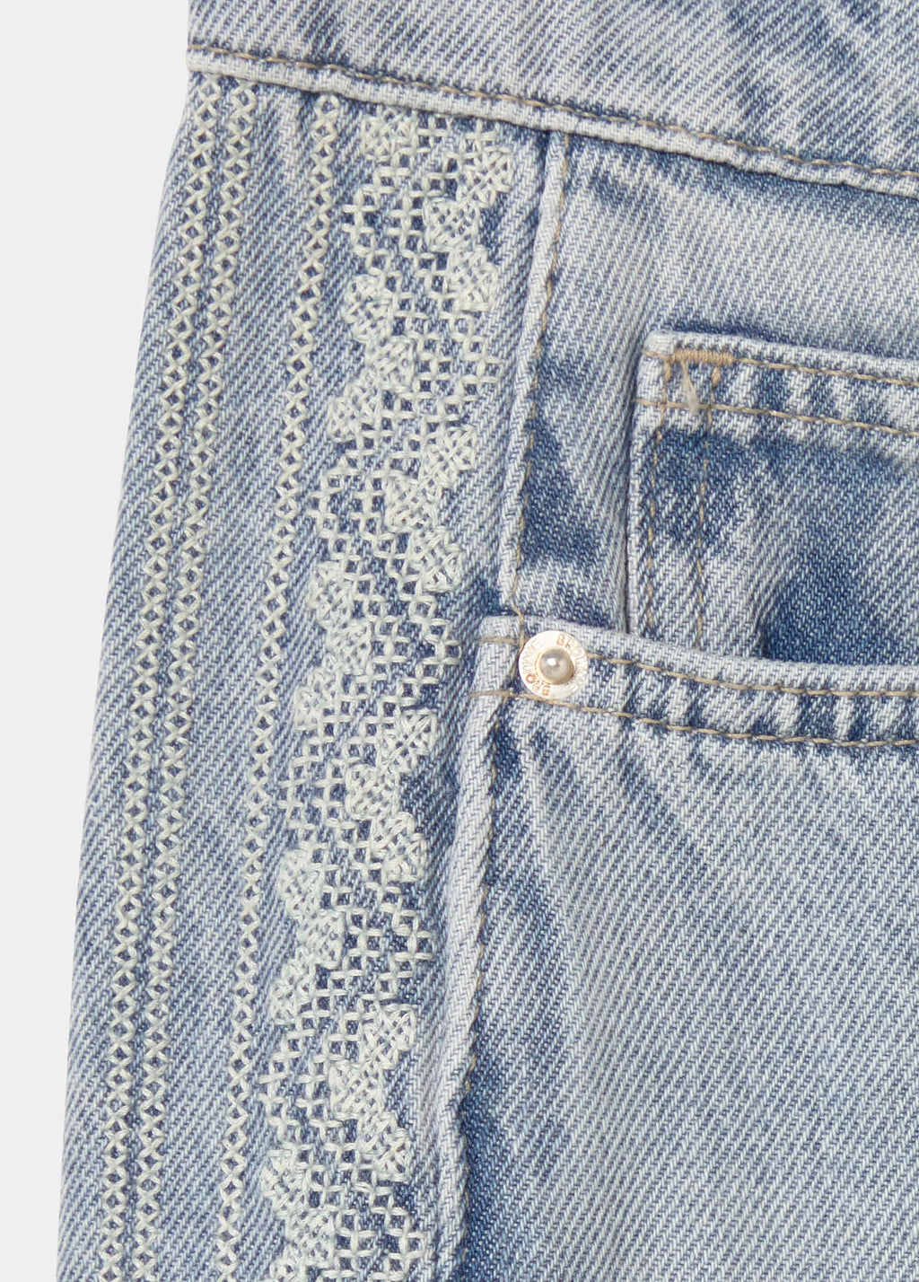 Jeans pieza lateral punto cruz