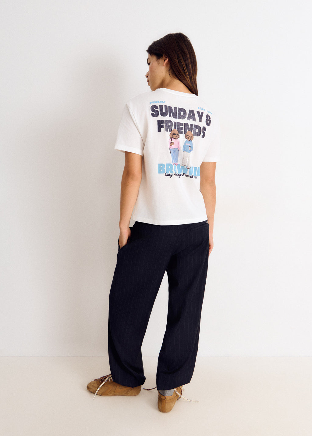 Camiseta blanca de manga corta vista por detrás con estampado de perros y texto en la espalda