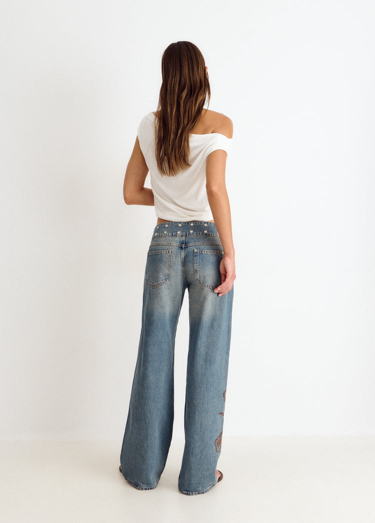Jeans with studded waistband and embroidery
