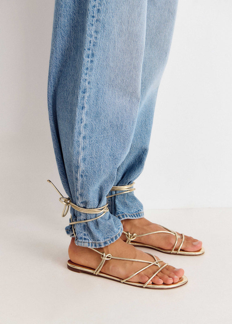 Flat sandals with tied straps